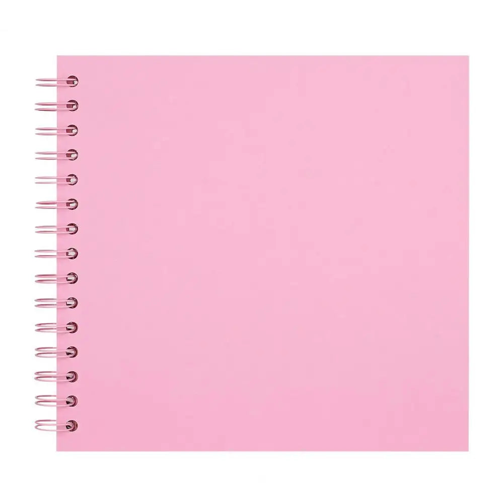 A blank pink spiral-bound notebook or scrapbook album.