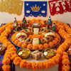 A circular arrangement of artificial orange marigold flowers with stems used for Day of the Dead decorations.