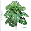 Artificial Monstera plant with silk green leaves shown against a white background.