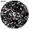 A circular black and white design featuring various cartoon skulls and skeletal elements for decoration.