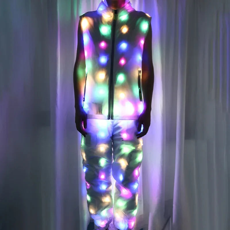 A person wearing a light-up neon costume jacket and pants set that glows with various colors.