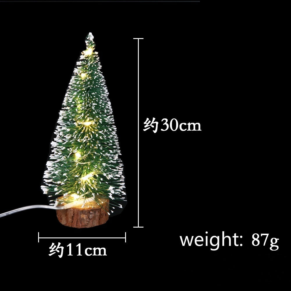 A small, illuminated LED Christmas tree with a snow effect, approximately 30cm tall and weighing 87g.