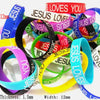 A collection of silicone bracelets featuring the Jesus Loves You design in various colors and thicknesses.