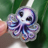 Silver glitter acrylic charm shaped like a purple and blue octopus for DIY hair bows