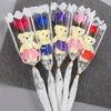 A bouquet of artificial rose soap featuring yellow and purple teddy bears in clear plastic wrappers.