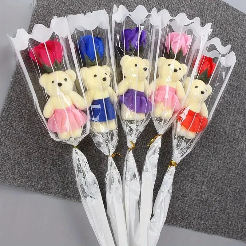 A bouquet of artificial rose soap featuring yellow and purple teddy bears in clear plastic wrappers.