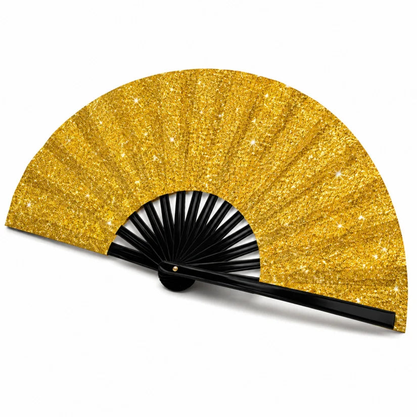 A golden, glittery hand fan with black ribs is shown open and angled.