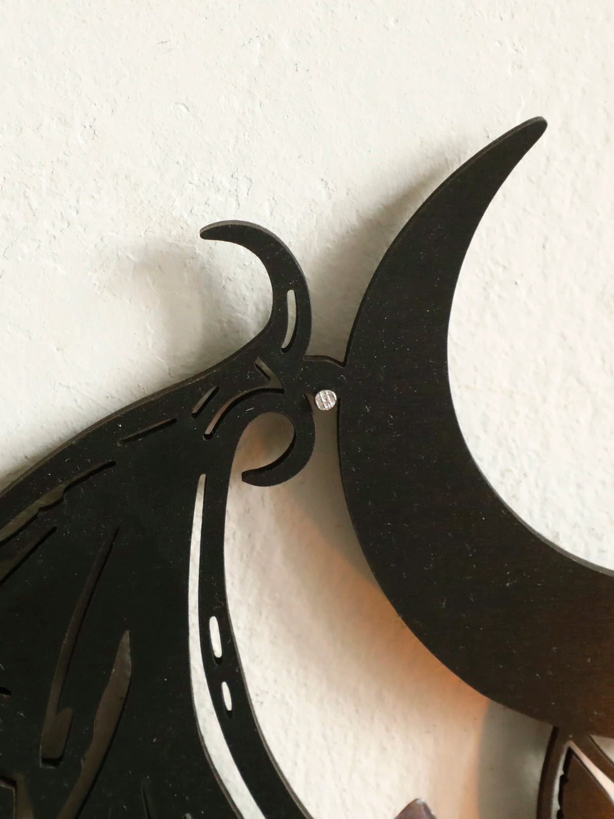 Black gothic bat and crescent moon wall decor mounted on a white wall