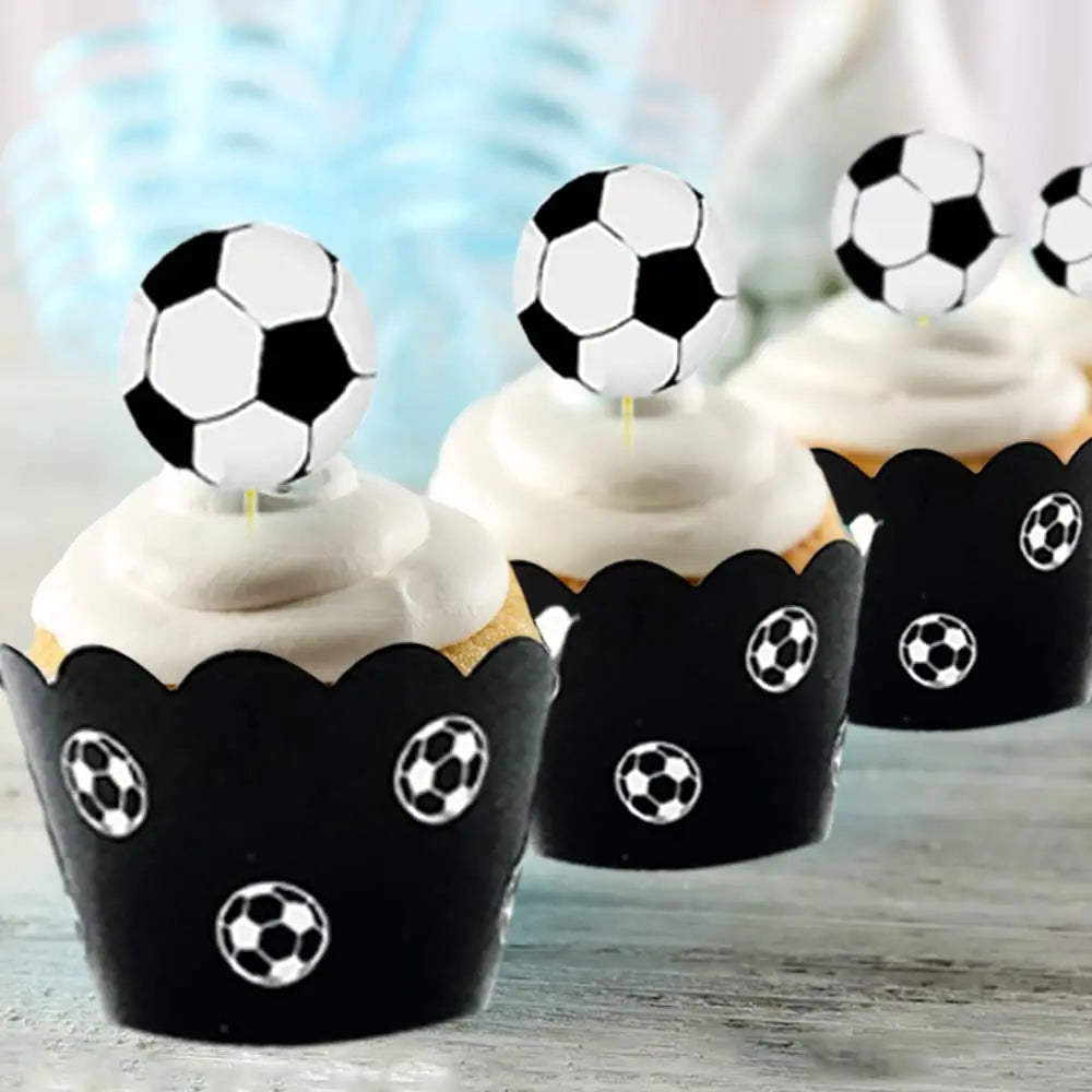 A set of black soccer ball cake toppers decorating cupcakes for a birthday party.