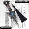 Gothic Kunai utility knife with a dark decorative blade and blue gemstone, used as a desk ornament.