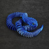 A vibrant blue 3D printed rotatable snake art model resting on a dark surface.