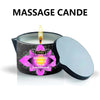 A massage candle in a tin with a lit wick and a silver lid.