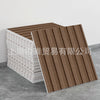 A stack of brown wood-look peel-and-stick tiles and white tiles are displayed on a gray surface.