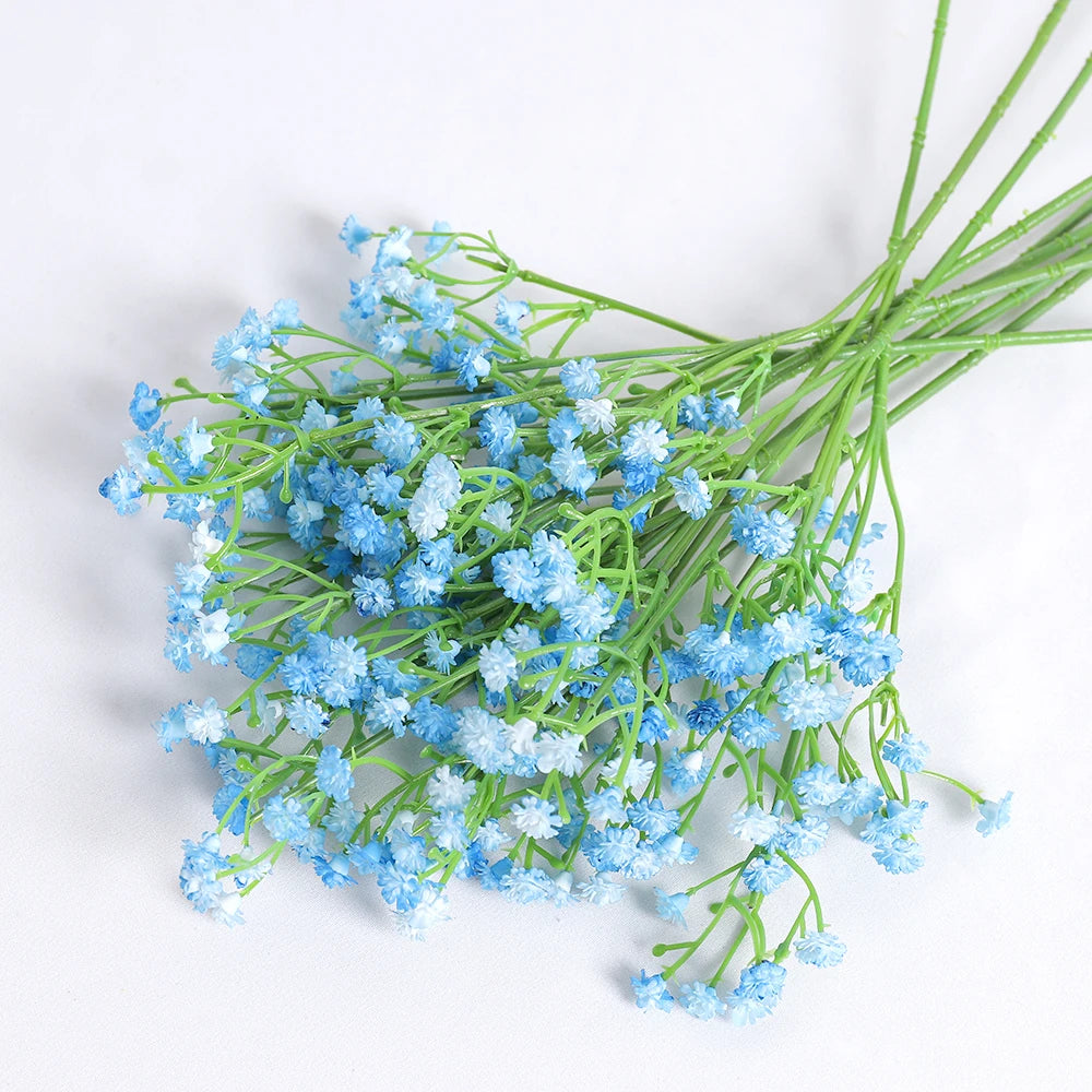 A bunch of artificial baby's breath flowers in light blue clustered on green stems.