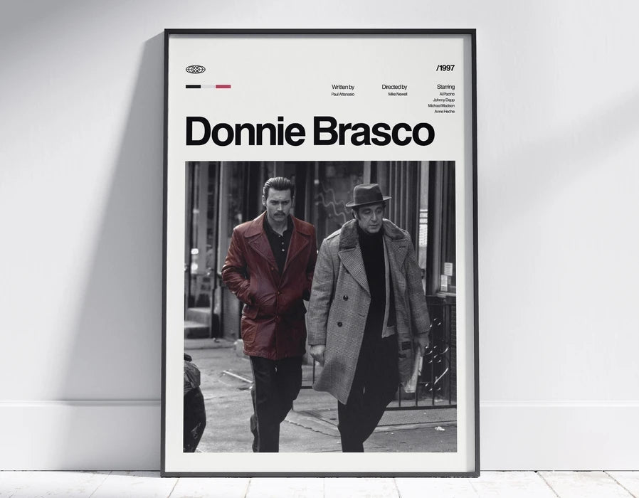 A framed black and white poster featuring a scene from a movie, titled Donnie Brasco, with credits and a 1997 date.