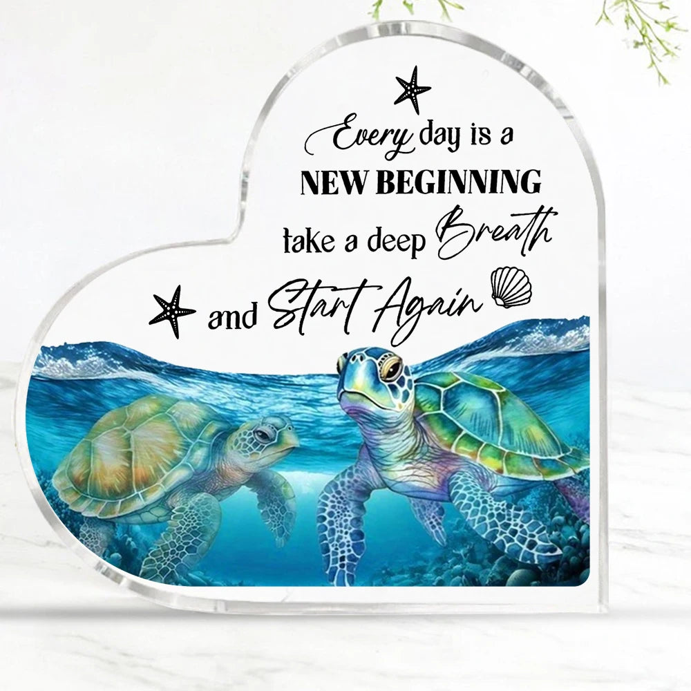 Acrylic heart-shaped decor featuring a blue sea turtle and inspirational text about new beginnings.