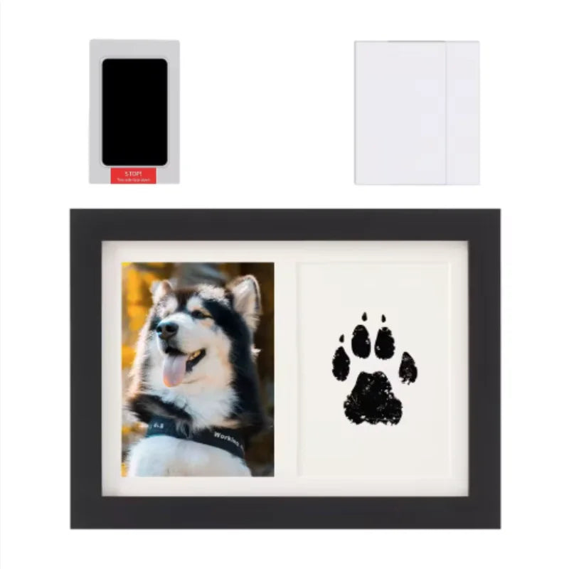 A black wooden photo frame displaying a paw print design, with a separate ink pad and frame components shown.