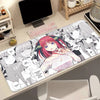 A desk mat featuring artwork of the Quintessential Quintuplets anime characters with a non-slip rubber base.
