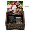 A wooden music box featuring figurines of a married couple, including a woman and a man, with a crank mechanism.