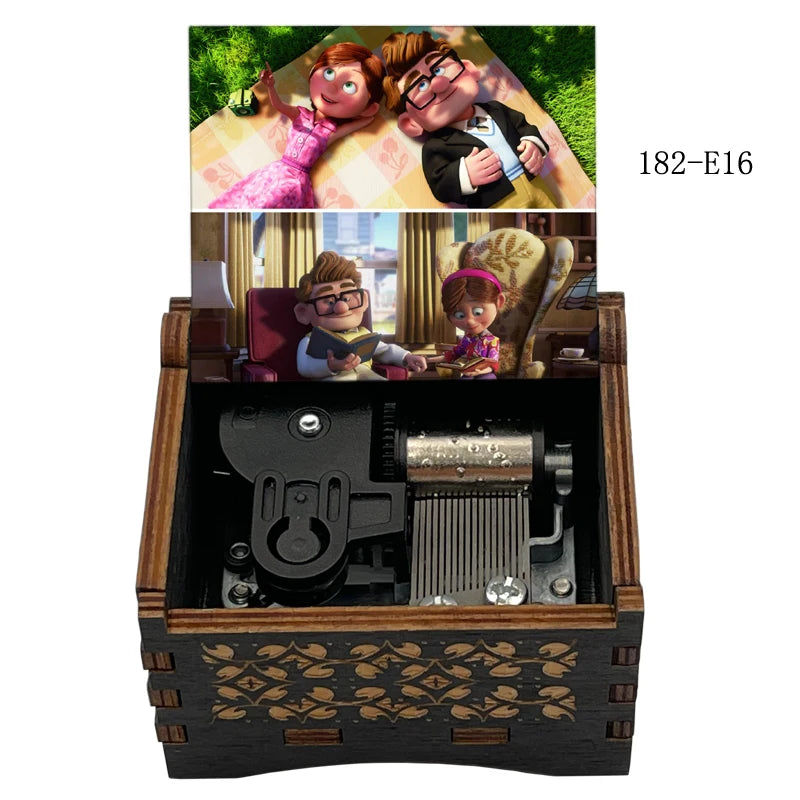 A wooden music box featuring figurines of a married couple, including a woman and a man, with a crank mechanism.