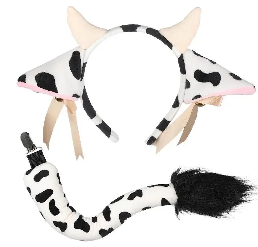 White cow print headband featuring cow ears, bells, and a ribbon bow.