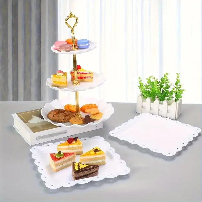 A gold-colored three-tiered serving stand displaying various colorful desserts and pastries on white plates.