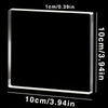 A square clear acrylic photo ornament with custom text engraved on the surface.