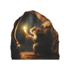 A small brown mouse holds a lit candle inside a hollowed-out log or wood carving.