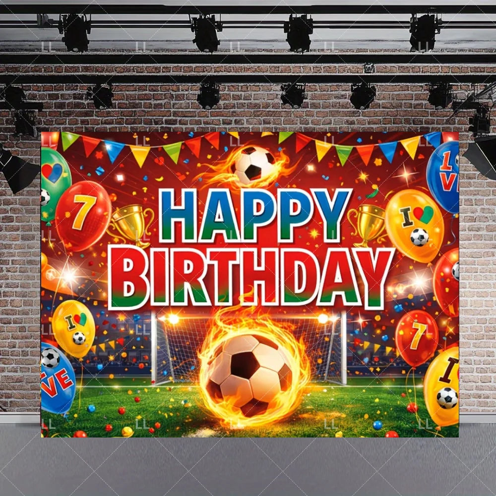 A vibrant soccer field party backdrop featuring a football, balloons, and birthday text on a brick wall.