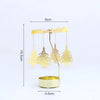 A gold rotating candle holder with three branches holding tealight candles, shown against a white background.