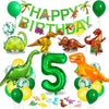 A colorful dinosaur party decoration kit featuring foil balloons, a banner, and a cake topper.