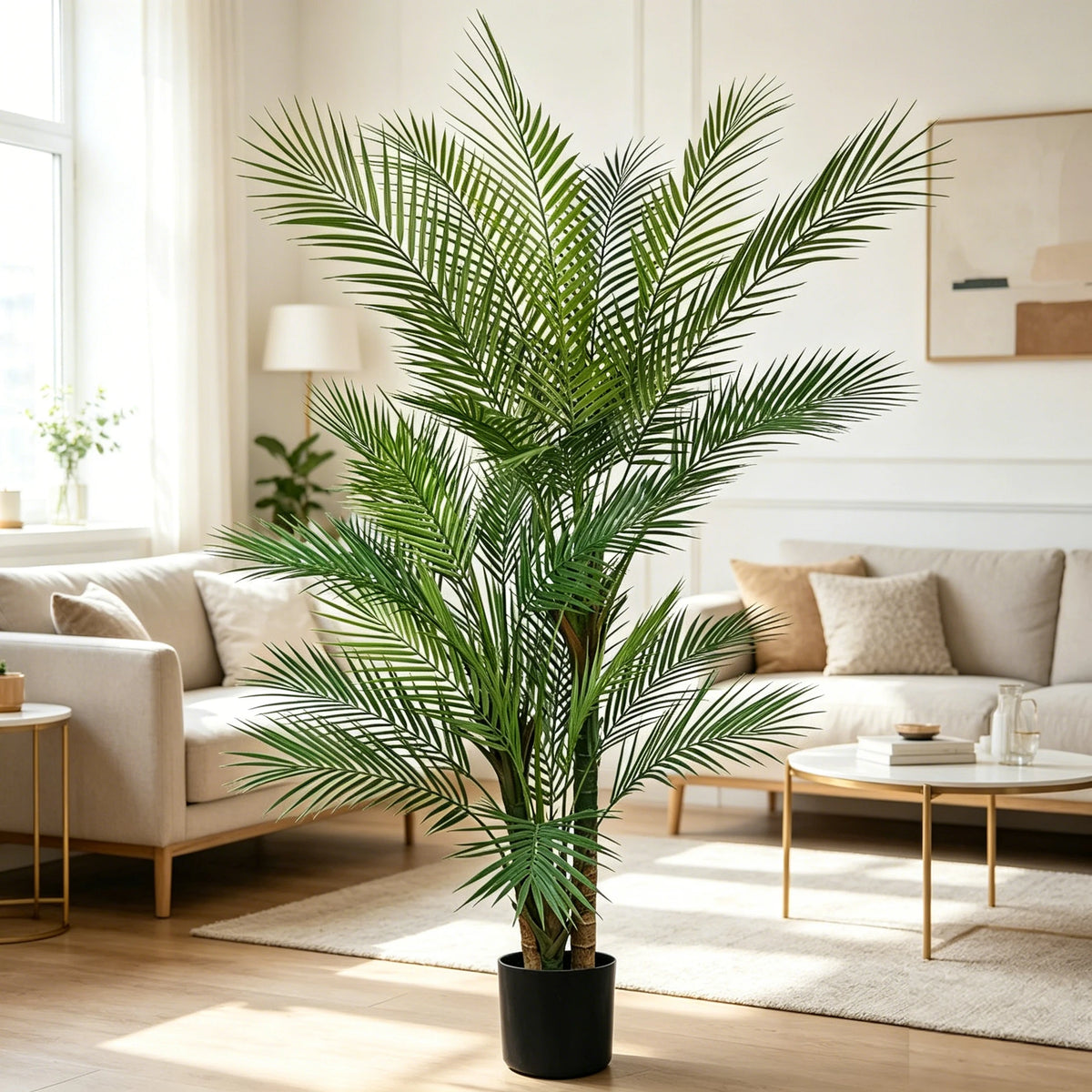 An artificial triple trunk palm tree in a black pot standing in a bright, modern living room.