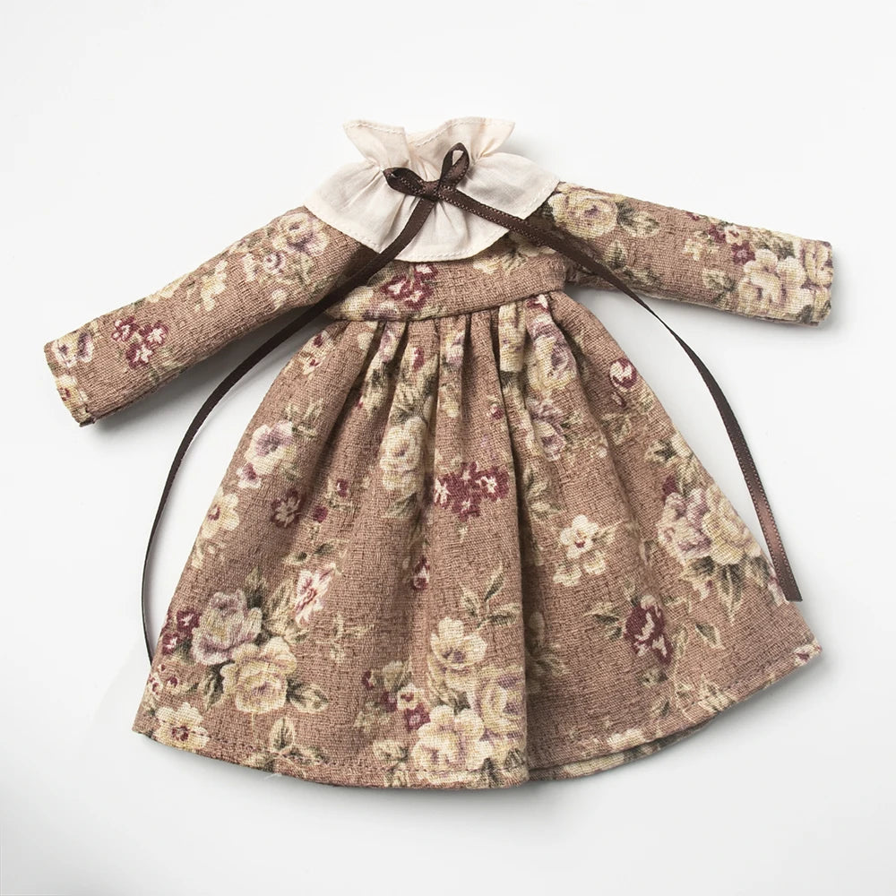 Vintage lace pajama set for a doll featuring a floral print in beige and pink tones.