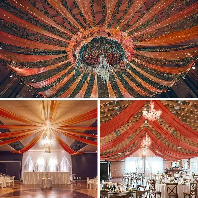 A dramatic ceiling installation featuring dark green sheer chiffon curtains and orange draping for a wedding event.