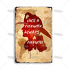 A vintage metal sign featuring a silhouette of a firefighter with the text Once a firefighter always a firefighter on a distr