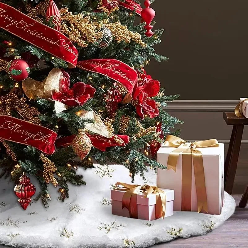 A festive Christmas tree decorated with red ribbons and ornaments resting on a white faux fur surface.