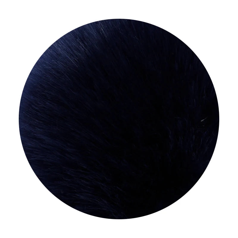 A round pom pom made of dark blue faux fur with a silver chain.