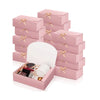 Pink kraft paper gift boxes stacked and displayed with ribbon ties.