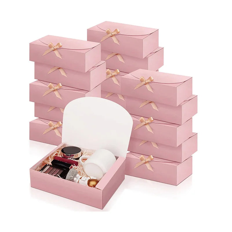 Pink kraft paper gift boxes stacked and displayed with ribbon ties.