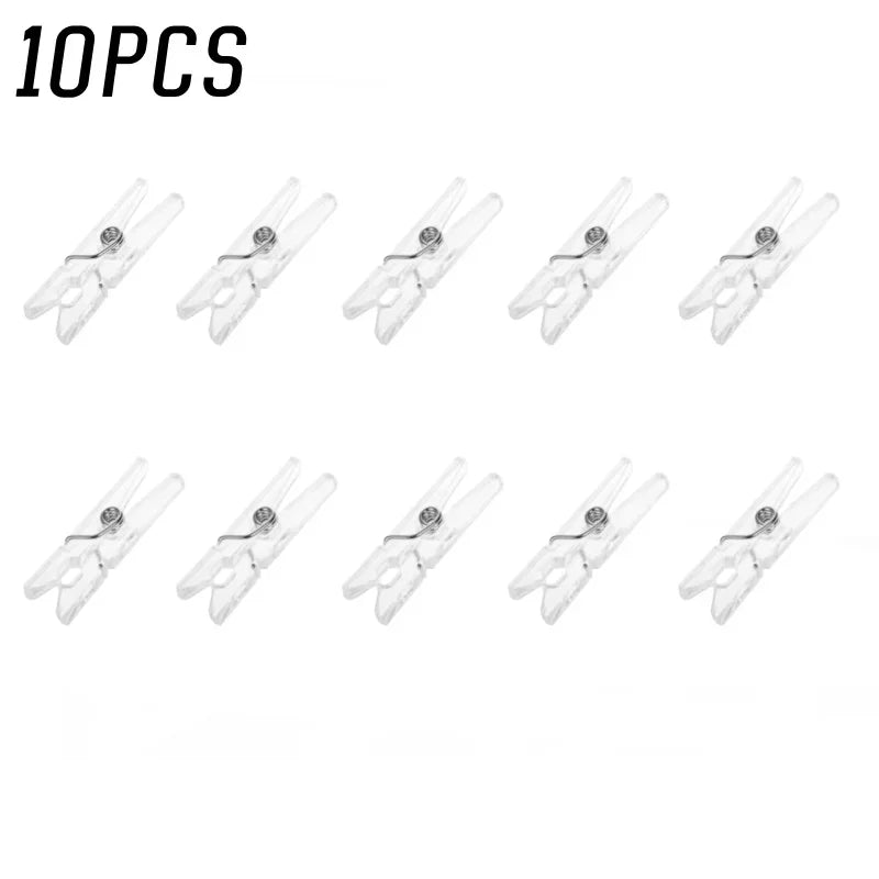 Ten mini clear plastic spring clips used for holding photos, papers, and crafts.
