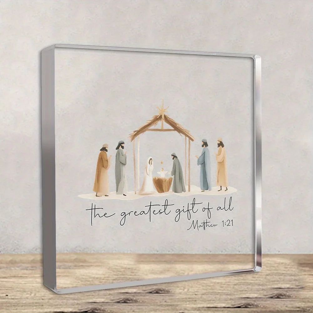 A framed artwork depicting a nativity scene with figures under a wooden shelter and the text The greatest gift of all Matthew