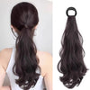 Long black heat resistant synthetic ponytail hair extensions styled in a low ponytail