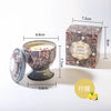 A gift set of soy wax aromatherapy candles in a decorative tin box and glass holder.