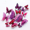 A set of twelve colorful 3D magnetic butterfly wall decor pieces in various shades of pink, purple, and red.