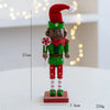 A handcrafted wooden nutcracker soldier figurine dressed in a green uniform with a red hat and holding a striped candy cane.