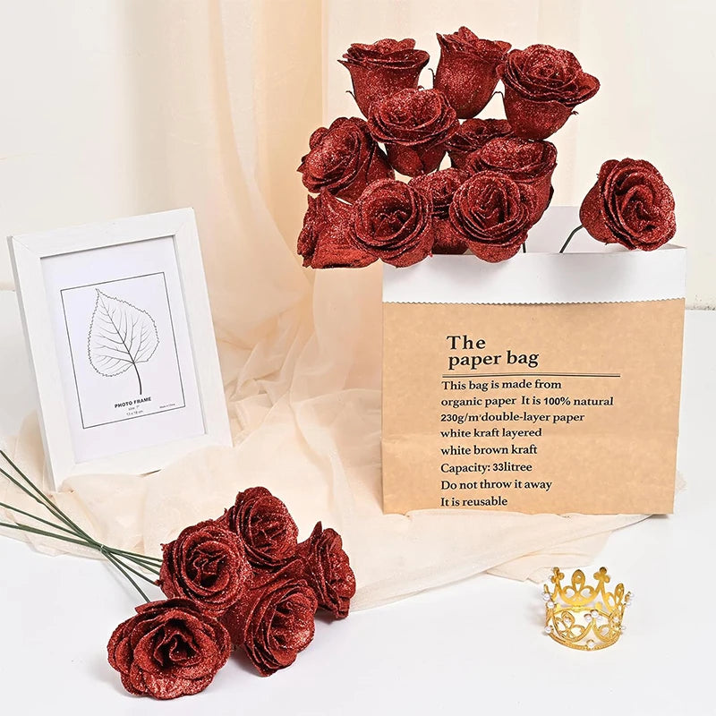 A set of ten deep red glitter artificial roses displayed in a kraft paper bag with a gold crown.