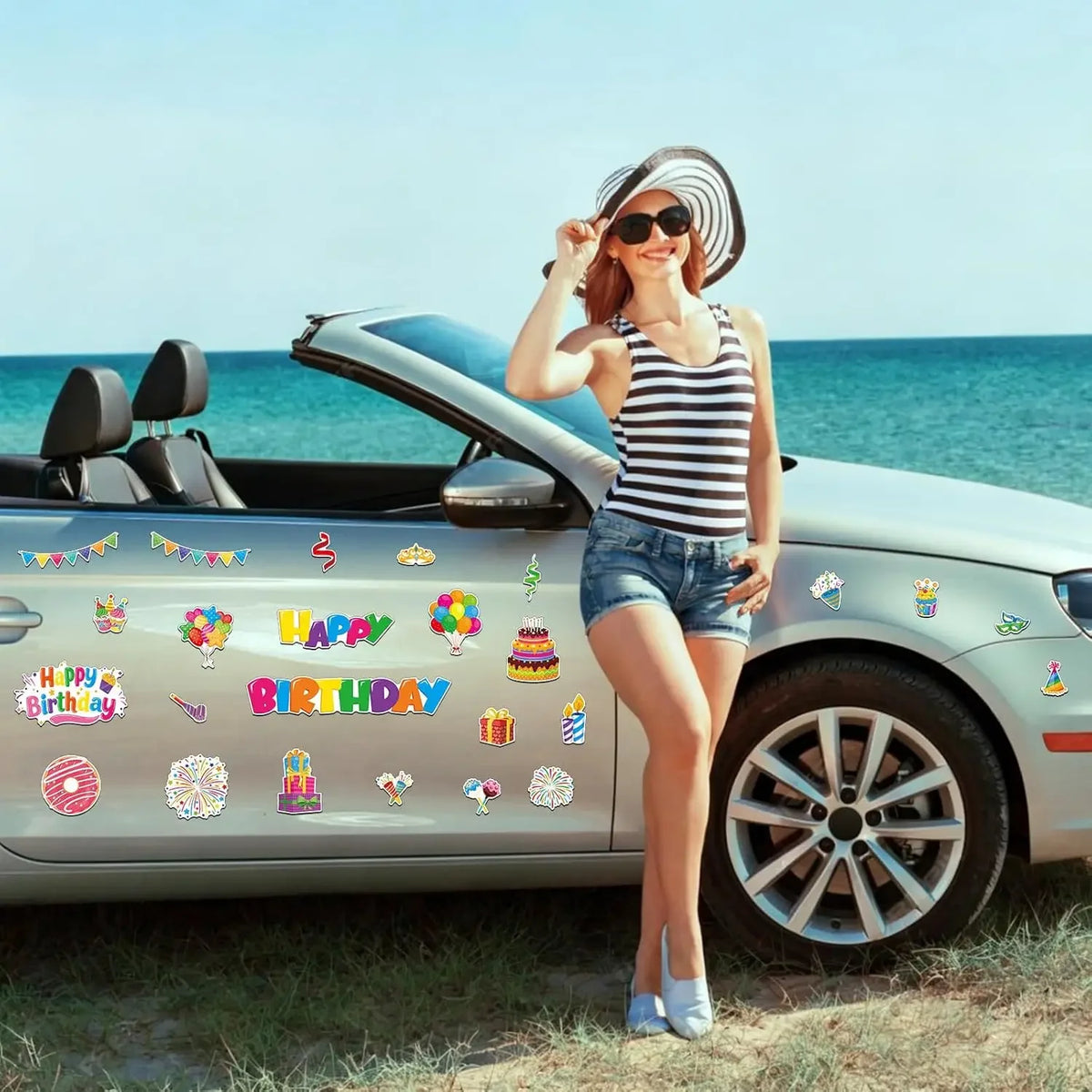 A woman smiling while posing next to a silver car with the door open, holding a hand near the car's body.