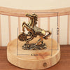 A solid copper figurine of a horse for prosperity and positive energy, displayed on a wooden base.