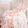 Pink sakura flower garland draped on a white tablecloth for weddings and events