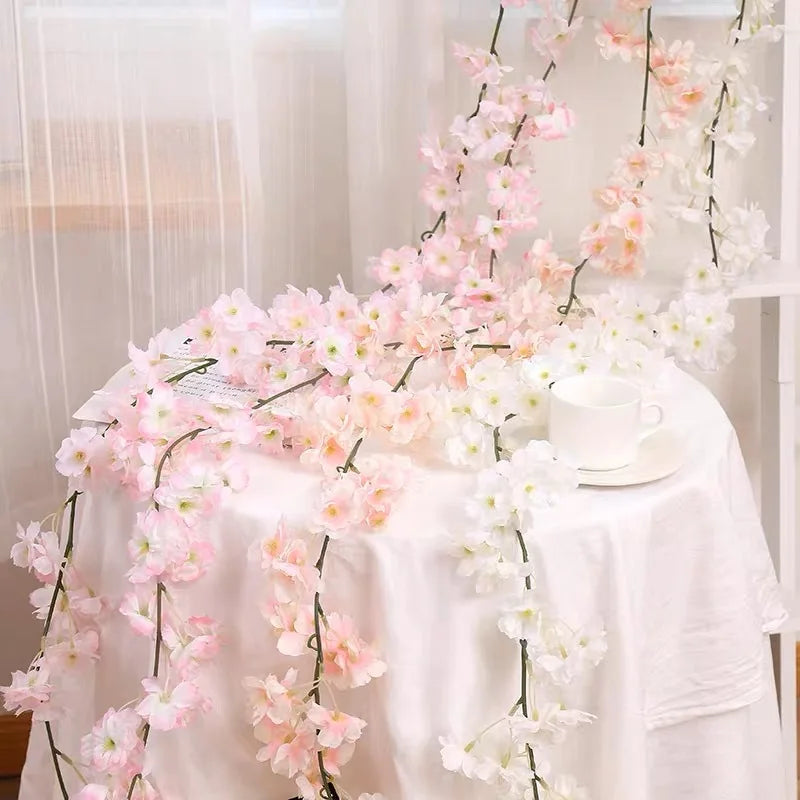 Pink sakura flower garland draped on a white tablecloth for weddings and events